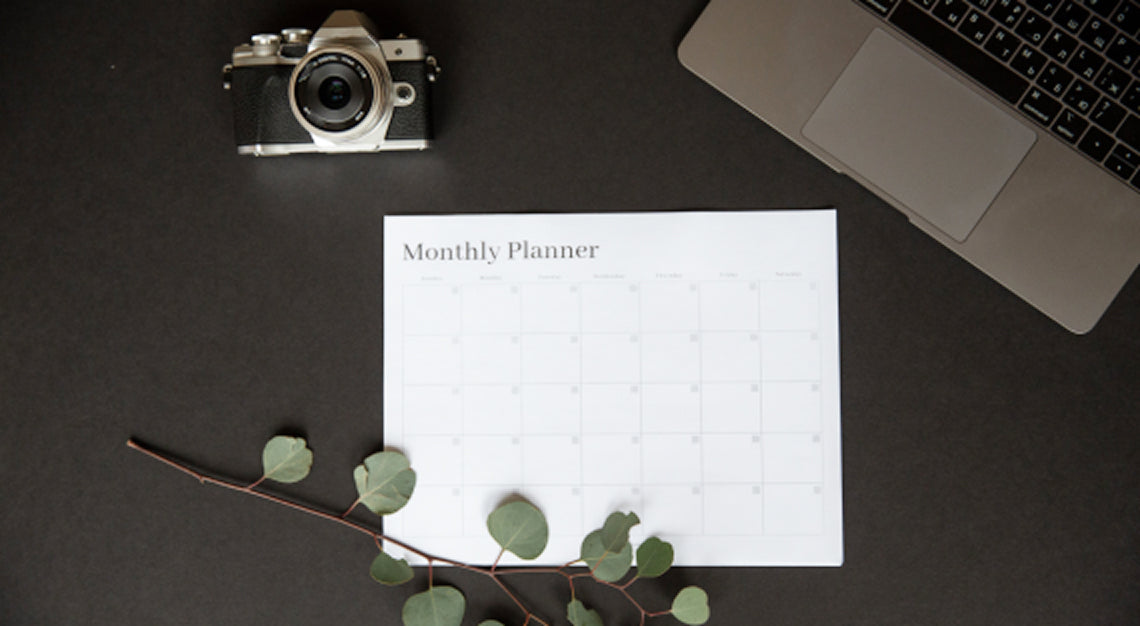 Camera equipment and lighting setup on a desk representing social media content planning for small brands