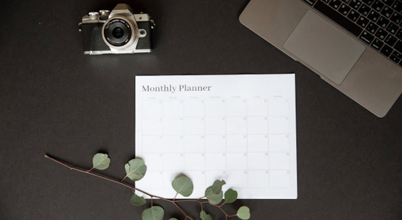 Camera equipment and lighting setup on a desk representing social media content planning for small brands