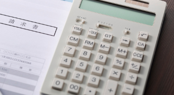 Calculator and pricing spreadsheet showing COGS and product cost breakdown for e-commerce