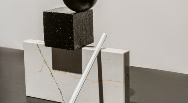 Geometric stone and wood shapes representing structure and clarity in writing better client emails