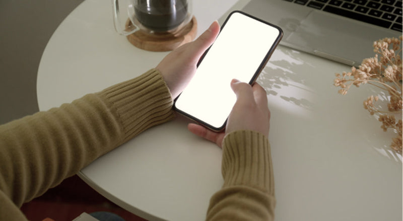 Person holding phone representing difference between Instagram and Xiaohongshu content strategy